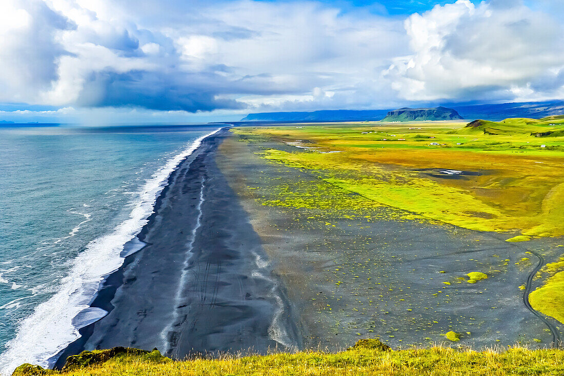 Green Patures Houses, Reynisfjara black sand beach, Dyrholaey Park South Shore, Iceland. Sand is black obsidian