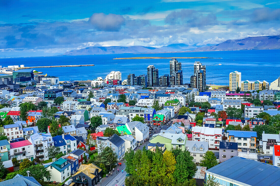 Colorful red green blue Houses Apartment Buildings Cars Bus Streets Ocean, Reykjavik, Iceland.
