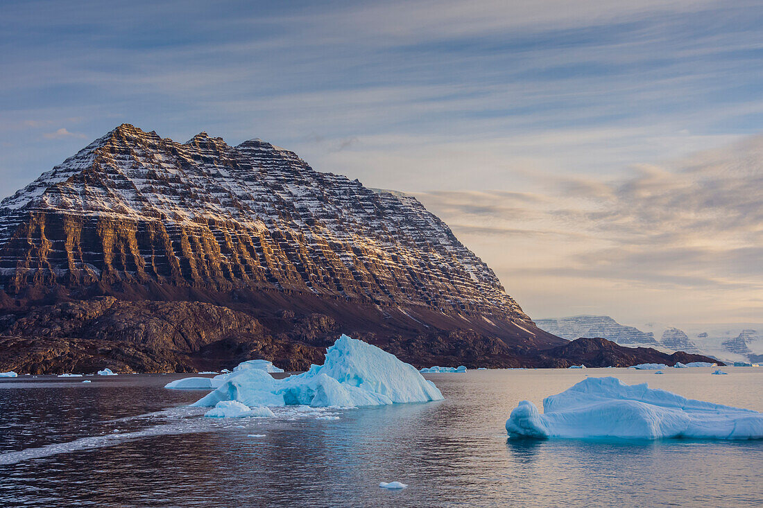 Greenland. Scoresby Sund. Icebergs and deeply eroded mountains.