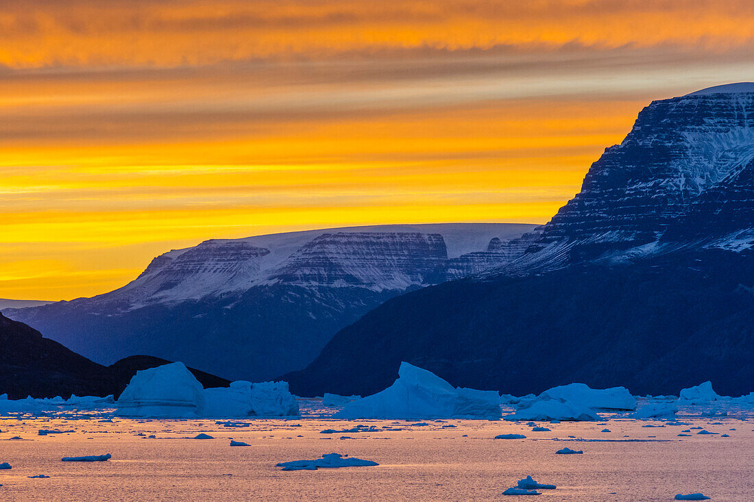 Greenland. Scoresby Sund. Gasefjord. Sunset with icebergs and brash ice.