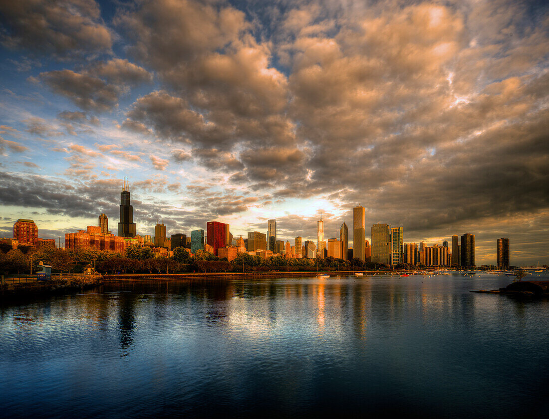 Chicago skyline shimmers at sunrise over lake Michigan