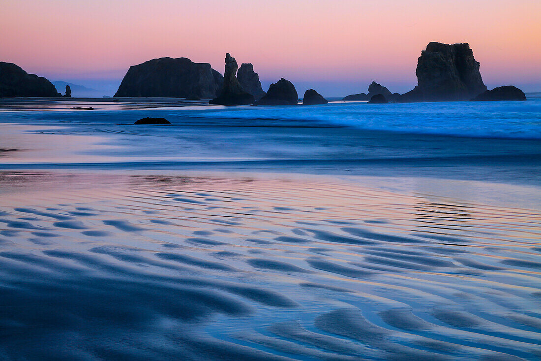 USA, Oregon, Bandon. Sunset on beach sea stacks