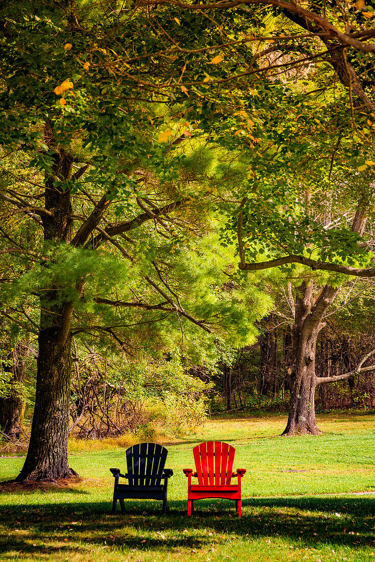 Colorful chairs on the banks of the lake, Peaks Of Otter, Blue Ridge Parkway, Smoky Mountains, USA.