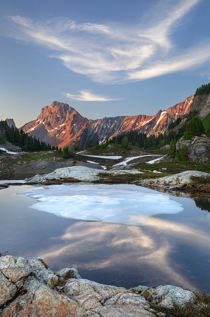 Partially thawed tarn, Yellow Aster Butte Basin. American Border Peak and Yellow Aster Butte in the distance. Mount Baker Wilderness, North Cascades, Washington State