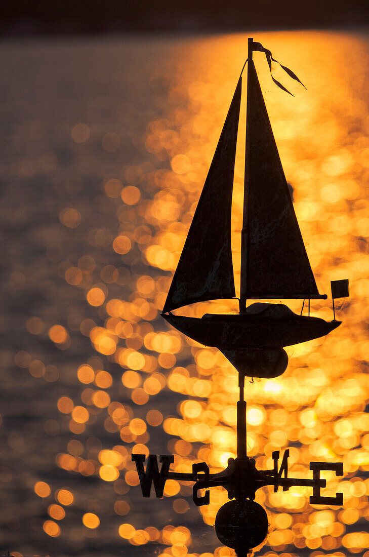 USA, Washington State, Kirkland, sailboat weathervane and sparkling lake