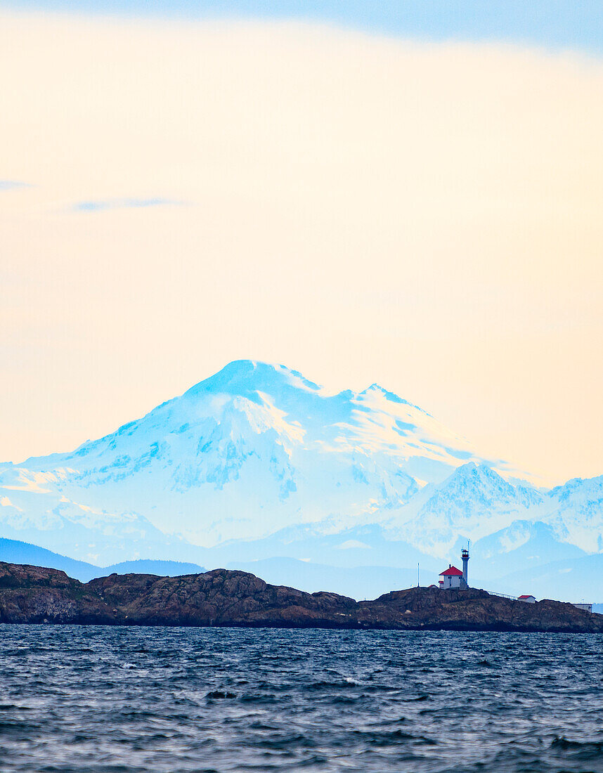 Discovery Island Lighthouse, Victoria, B.C. against Mt. Baker in Washington State