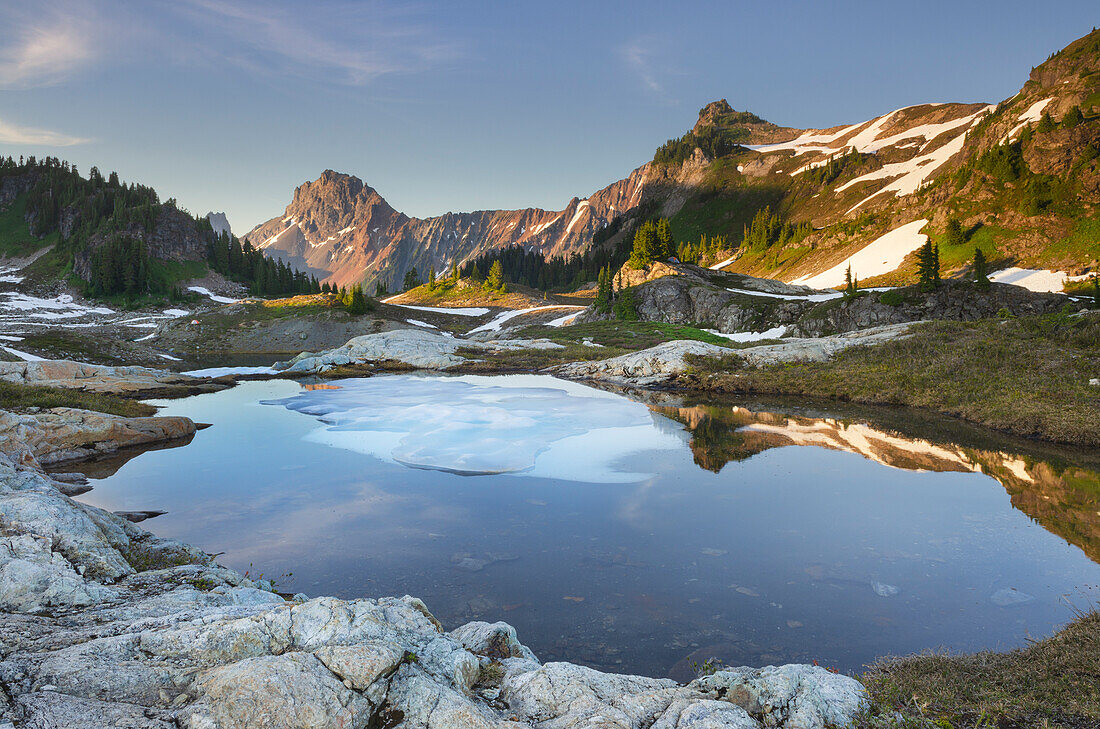 Partially thawed tarn, Yellow Aster Butte Basin. American Border Peak is in the distance. Mount Baker Wilderness, North Cascades, Washington State