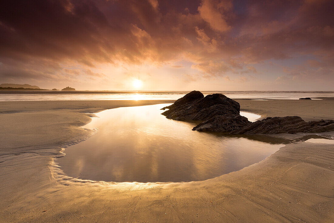 USA, Washington State, Olympic National Park. Sunrise on coast beach and rocks.