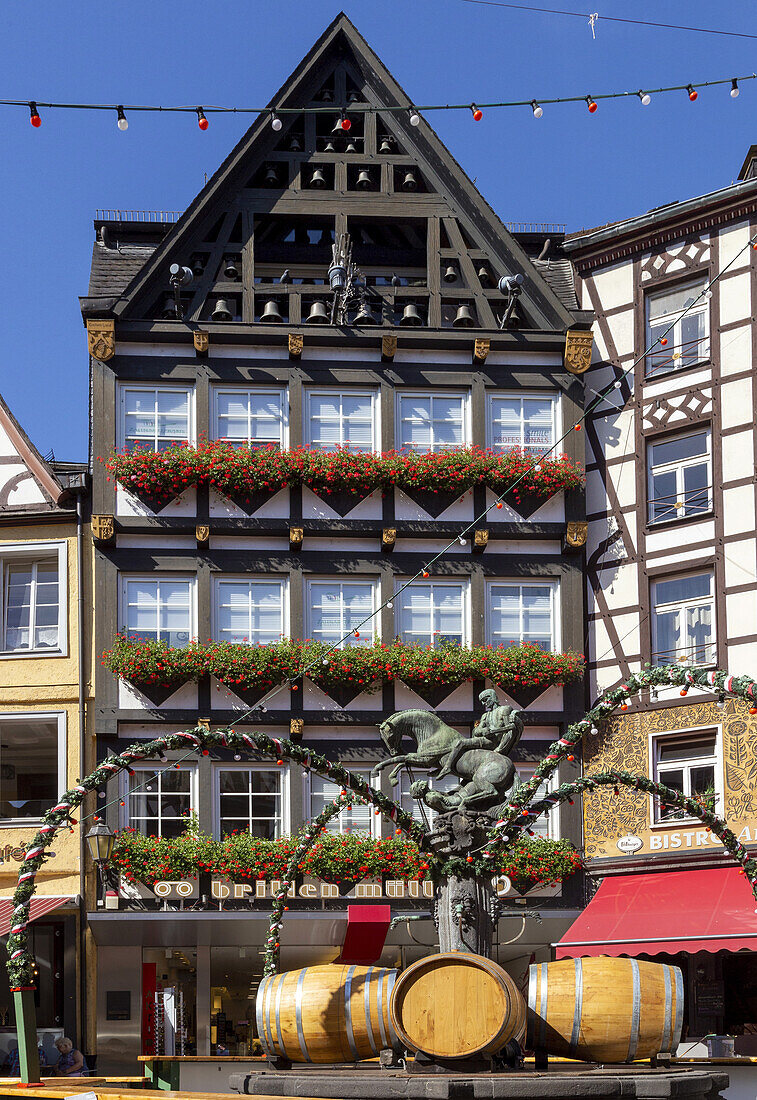 Half-timbered house, market square, St. Martin fountain with wine barrels, old town, Cochem on the Moselle