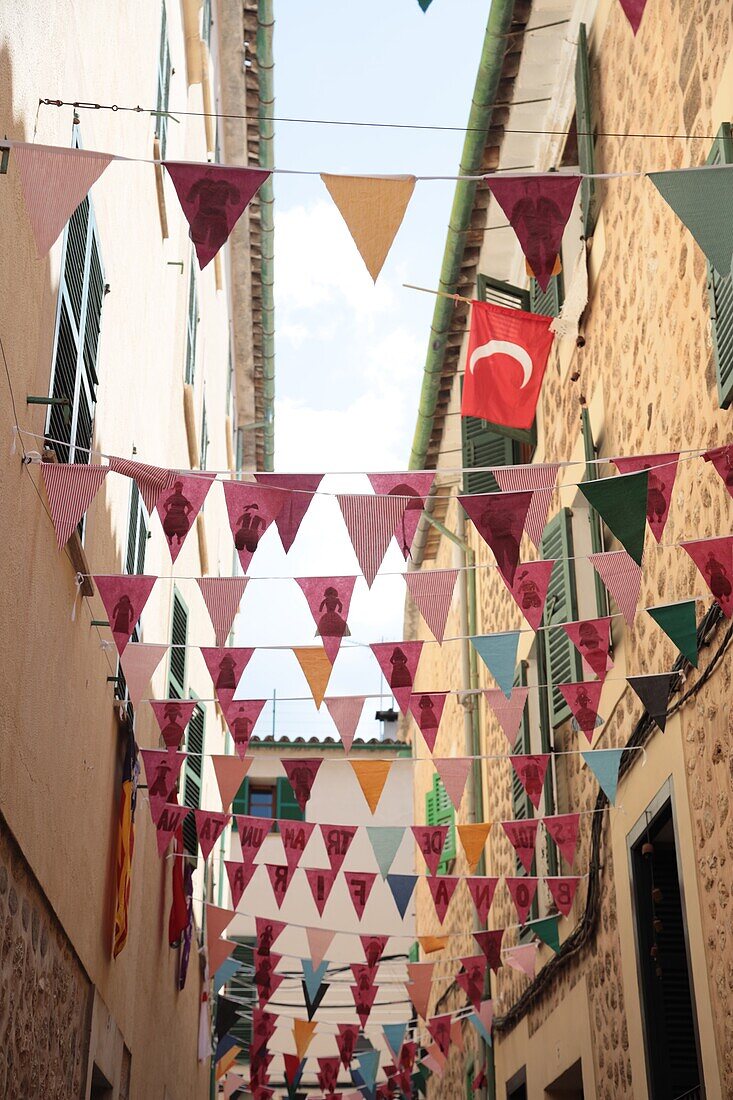 Buntings over the streets for the Sa Fira festival on the beach in Port de Soller, Mallorca, Spain