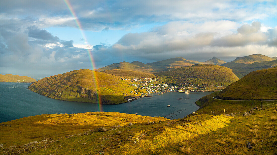 Europe, Faroe Islands. View of the village of Vestmanna with rainbow on the island of Streymoy