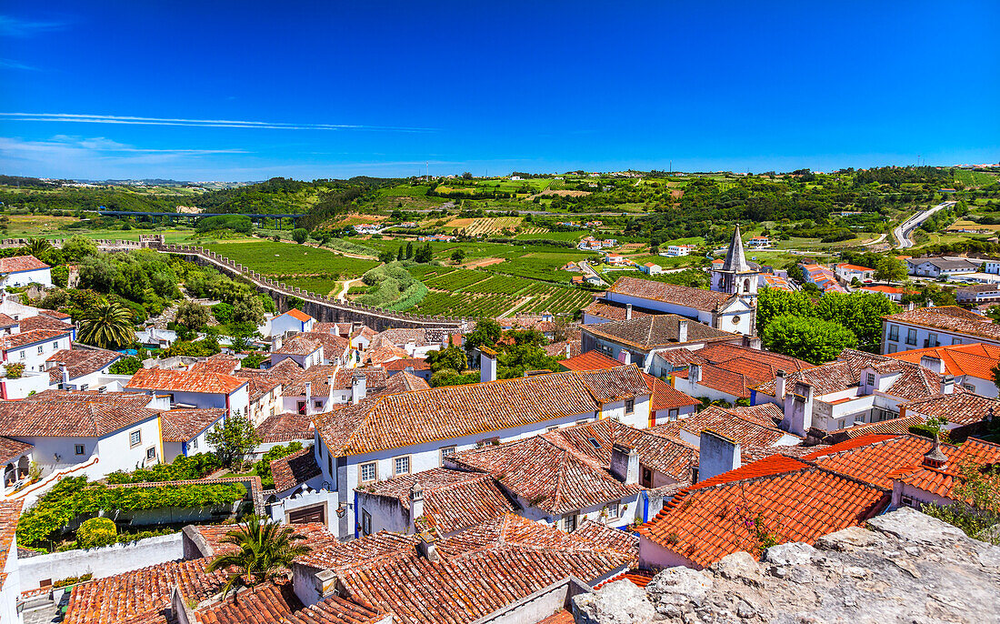 Burgmauern, mittelalterliche Stadt auf dem Land, Kirche Santa Marica, Obidos, Portugal. Burg und Mauern, die im 11. Jahrhundert erbaut wurden, nachdem die Stadt den Mauren abgenommen wurde.