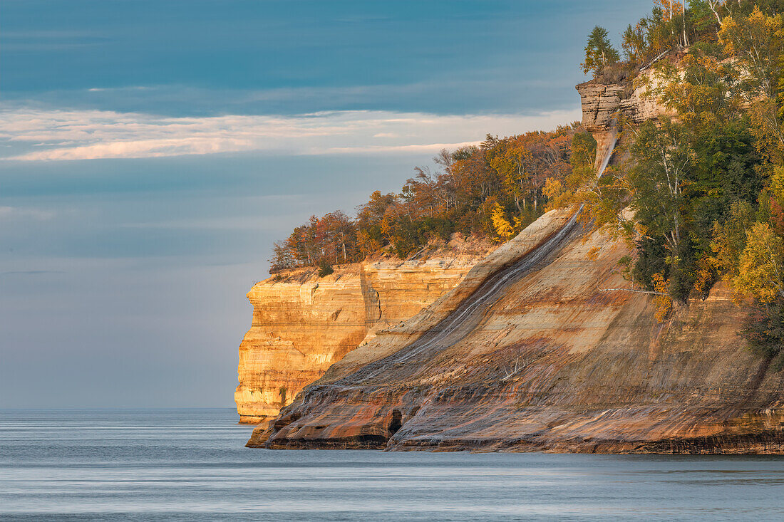 View of Bridalveil Falls and cliffs along Lake Superior coastline in autumn, Pictured Rocks National Lakeshore, Upper Peninsula of Michigan.