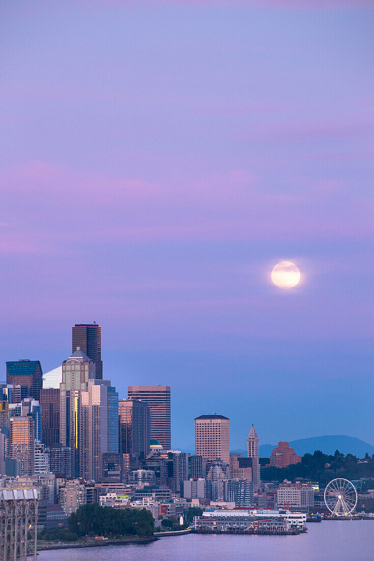 Downtown Seattle with a full moon rising in the evening sky, Seattle, Washington State.