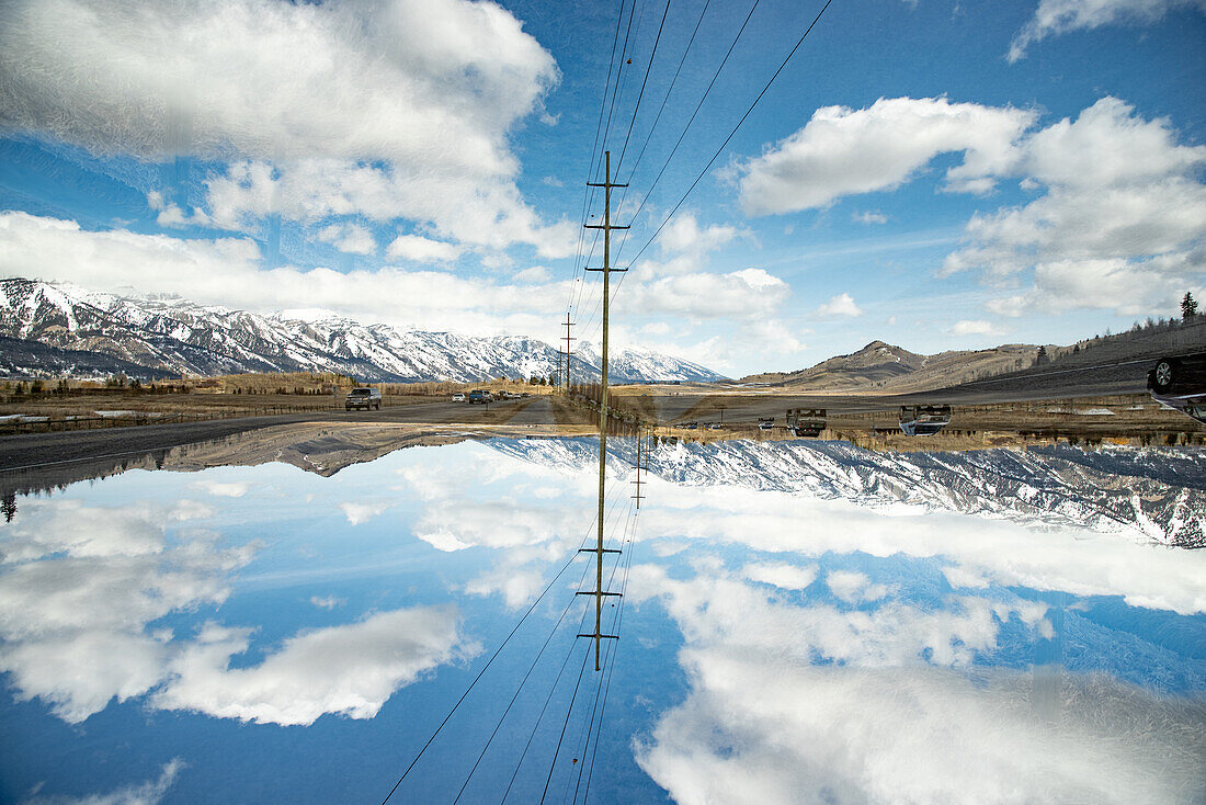 Powerlines in the landscape before the Grand Teton mountain range.