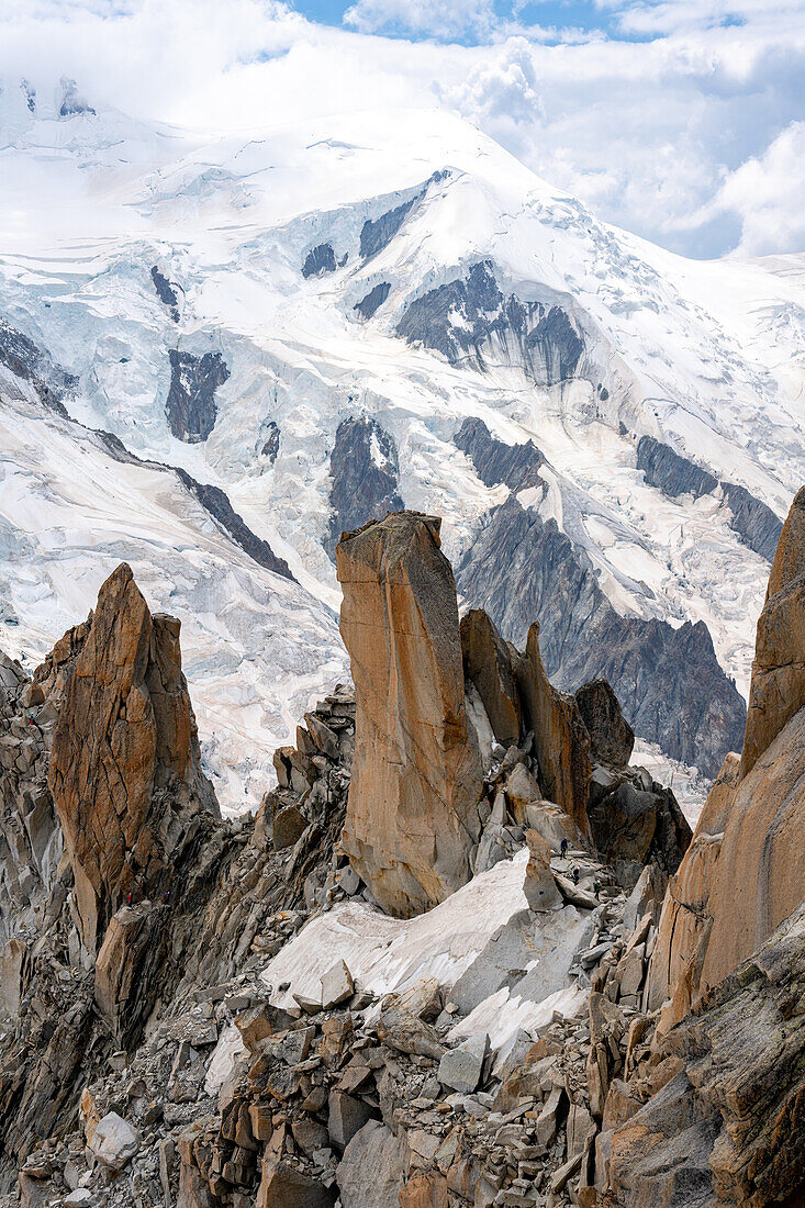 View from the Aiguille du Midi on a rock needle with mountaineers, Vallée de Chamonix-Mont-Blanc, Le Mont-Blanc, Bonneville, Haute-Savoie, Auvergne-Rhône-Alpes, France