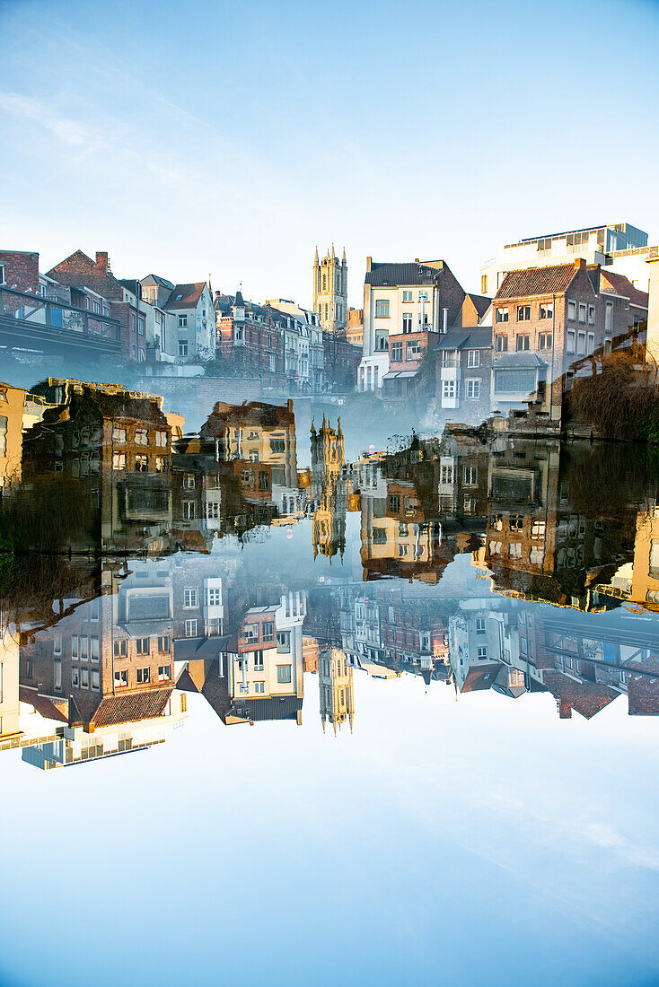 Double exposure photo of housing and St Bavo's cathedral reflected in water in Gent, Belgium