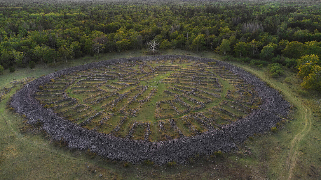 A bird's-eye view of the ruins of the Brug Ismantorp. Stone circle on forest clearing. Oland, Sweden.