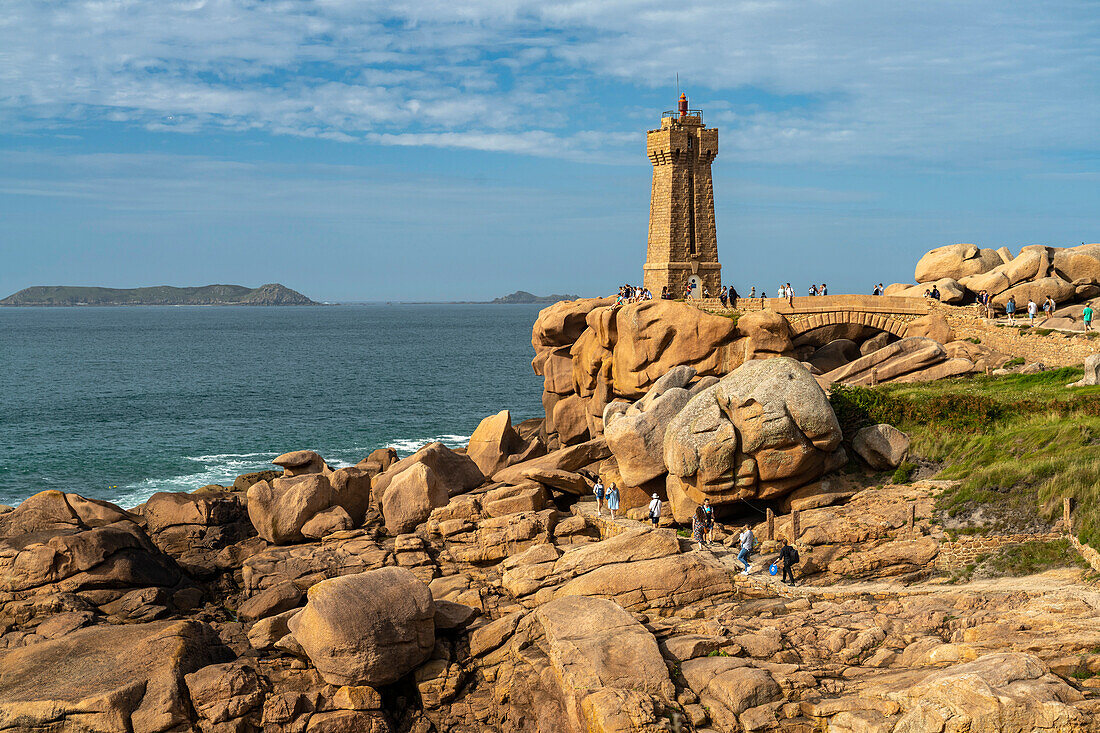 The rocks of the pink granite coast Côte de Granit Rose and the Phare de Ploumanac'h lighthouse at Ploumanac'h, Perros-Guirec, Brittany, France