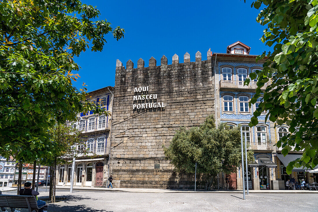 Aufschrift Aqui nasceu Portugal - Hier wurde Portugal geboren - auf dem Turm der alten Stadtmauer Torre de Alfandega in Guimaraes, Portugal, Europa