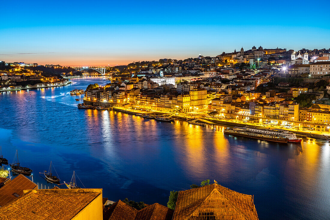 View across the Douro River to the old town of Porto at dusk, Portugal, Europe