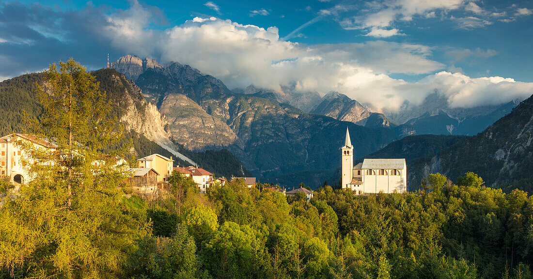 Evening sunlight over Chiesa di San Martino and the Dolomite Mountains near Venas di Cadore, Veneto, Italy