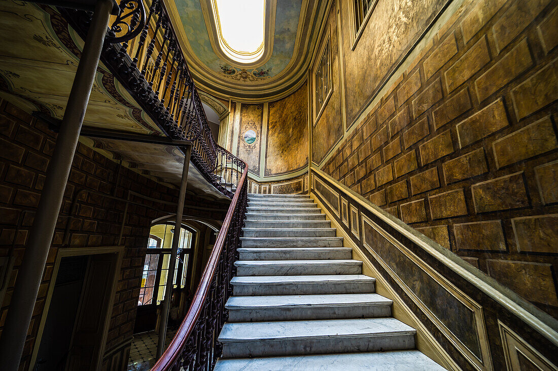 Interior of entrance hall with carved staircase in old maisons in Tbilisi's downtown, capital city of Georgia
