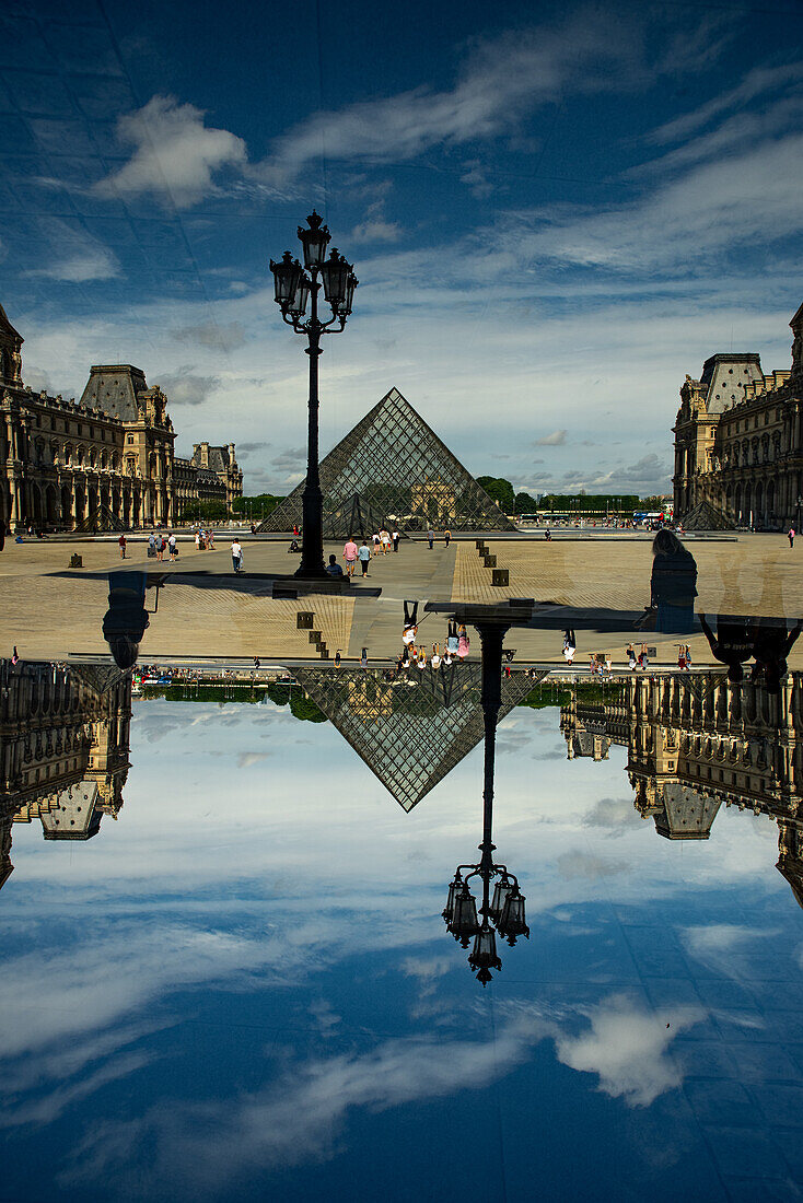 Double exposure of the glass pyramid entrance of the famed Louvre museum in Paris, France