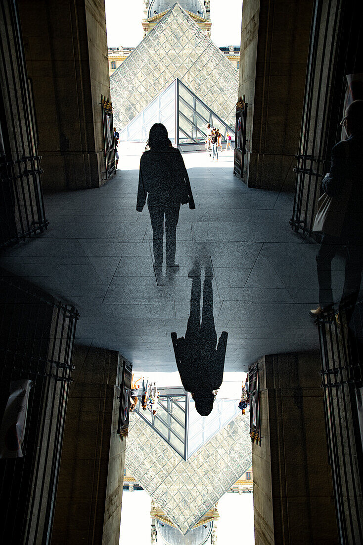 Double exposure of the glass pyramid entrance of the famed Louvre museum in Paris, France