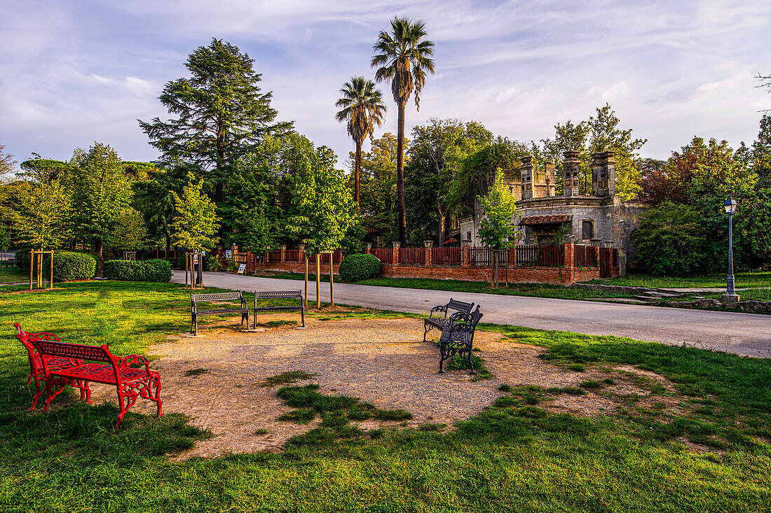 Historical benches in the Parco Termale, in the background the Terme Tamerici, Montecatini Terme, Tuscany, Italy