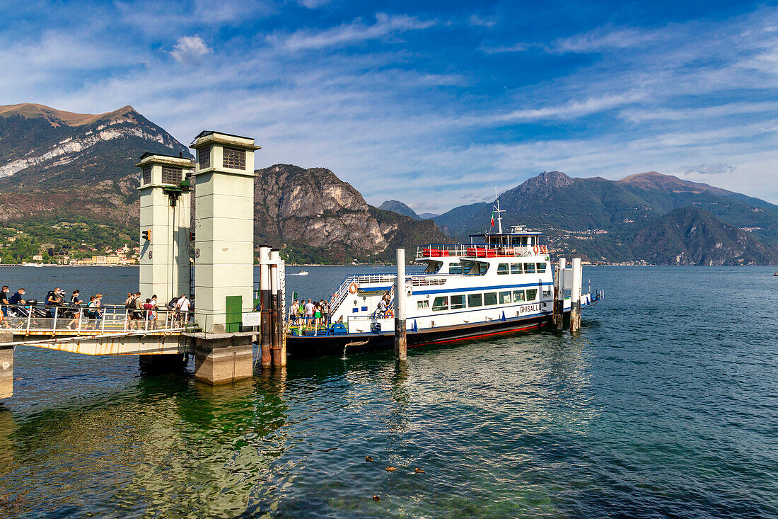 Tourists getting on the ferry, Bellagio, Como lake, Lombardy, Italy.