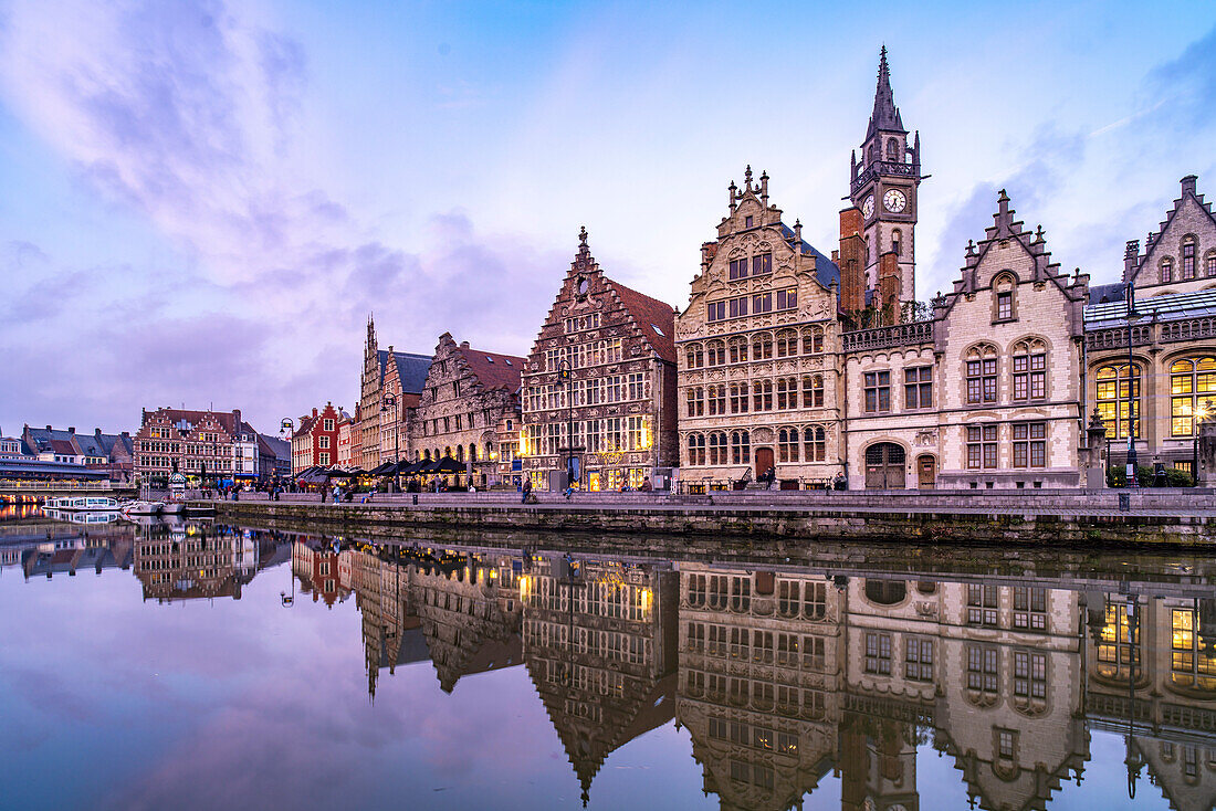 Medieval guild houses of the Graslei quay on the Leie river at dusk, Ghent, Belgium