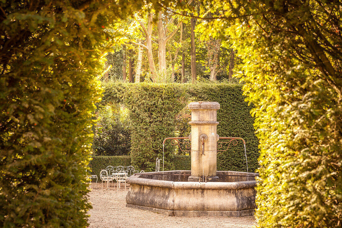 Old fountain in the Jardins de Pays d`Auge garden, Cambremer, Calvados, Normandy, France