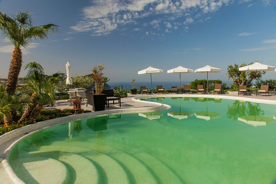 Swimming pool with umbrellas and sunbeds in Forio, Ischia Island, Gulf of Naples, Campania, Italy