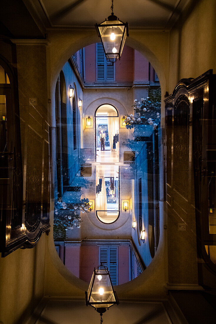 Arched passage in shopping street in Milan, Italy.