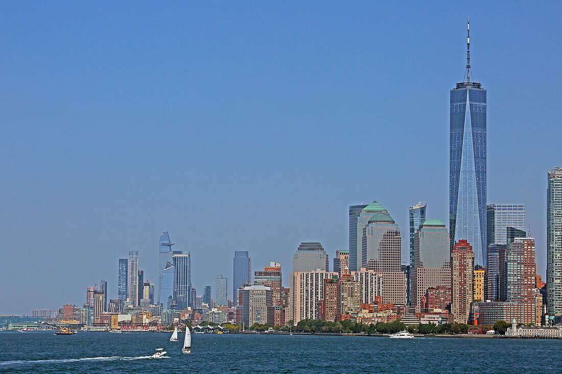 View from the Staten Island Ferry of the Financial District skyline at the southern tip of Manhattan, with the towers of the Hudson Yards in the background on the left, New York, New York, USA