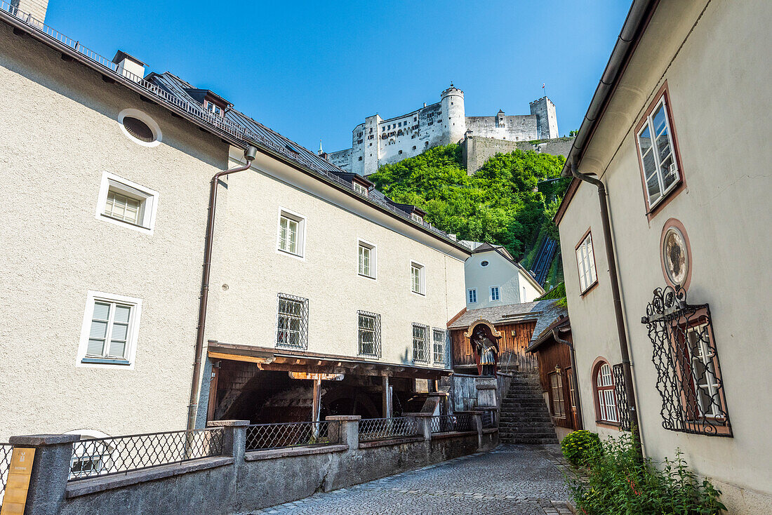 Alley in the city of Salzburg with a view of Hohensalzburg Fortress, Austria
