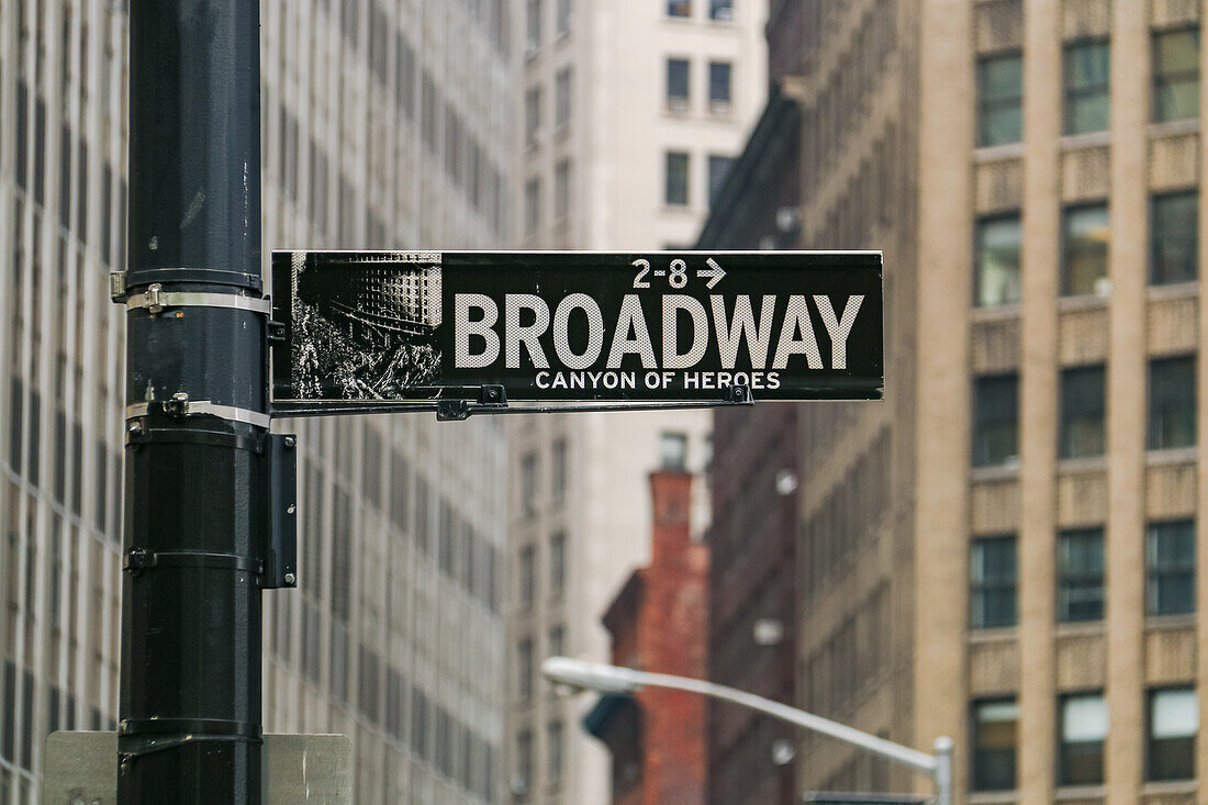 Street sign with reflective inscription Broadway - Canyon of Heroes in Manhattan, New York, United States of America