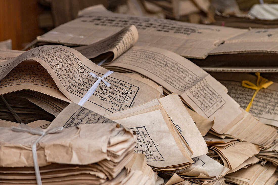 Stack of bound texts with Tibetan script at Kumbum Champa Ling Monastery near Xining, China