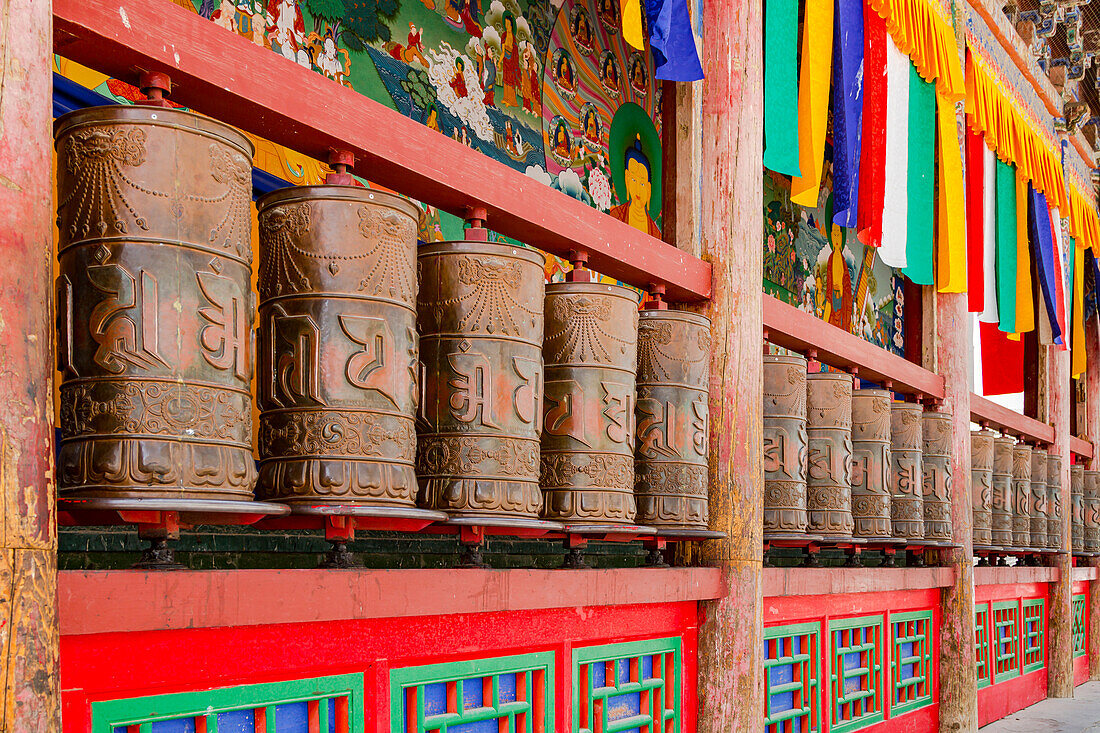 Vanishing point perspective of large fixed prayer wheels in a Tibetan monastery, Xining, China