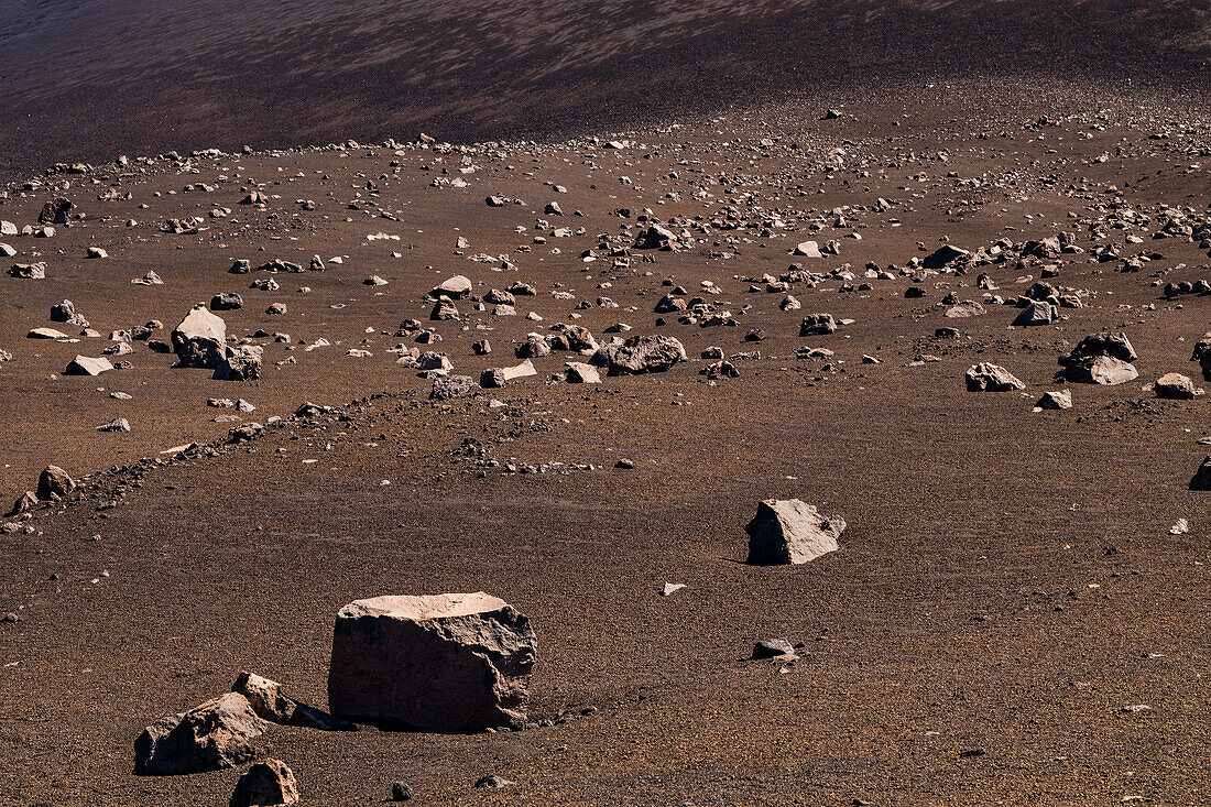 A flank of the Pico do Fogo volcano on the island of Fogo, Cape Verde, covered with stones and lava boulders