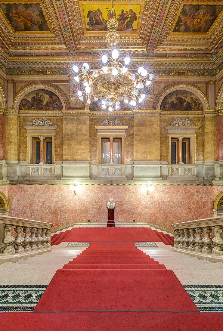 The Hungarian State Opera House, built in the 1880s, interior double staircase with a red carpet.