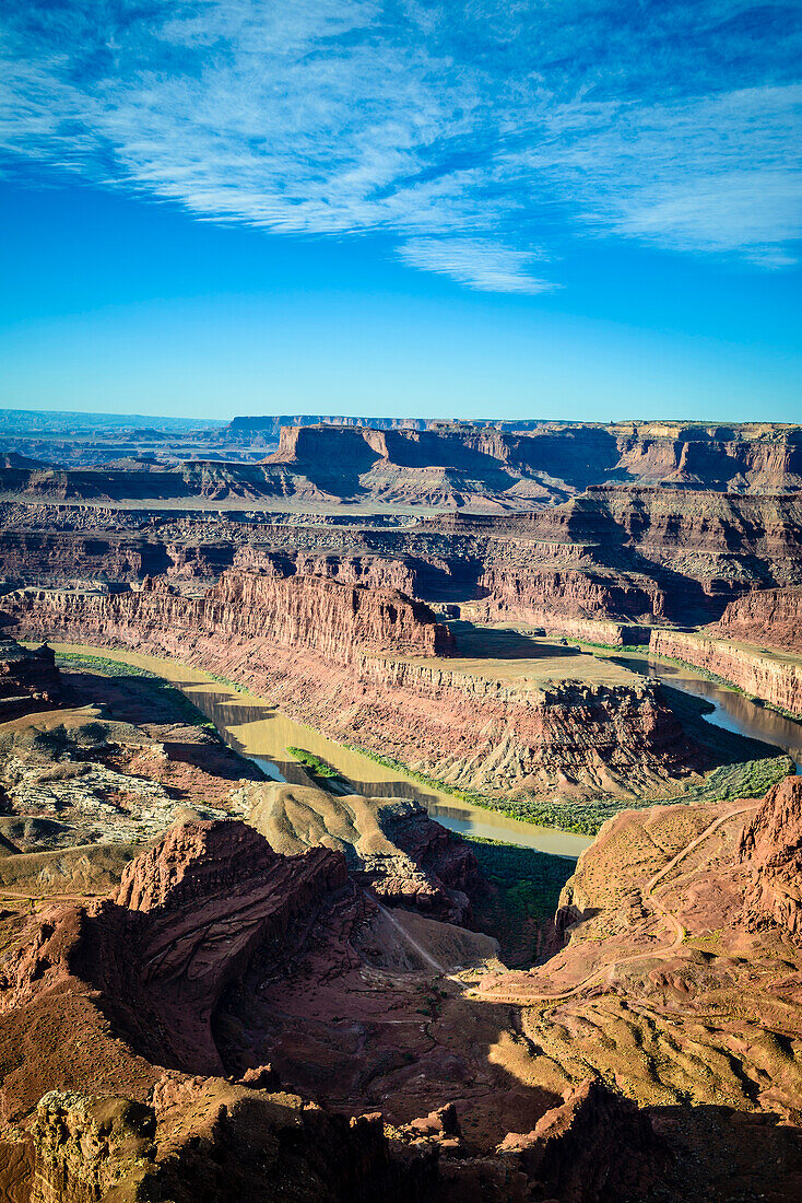 View from above of the messas and rock formations of Canyonlands National Park, and view to Horseshoe Bend and the Colorado River.