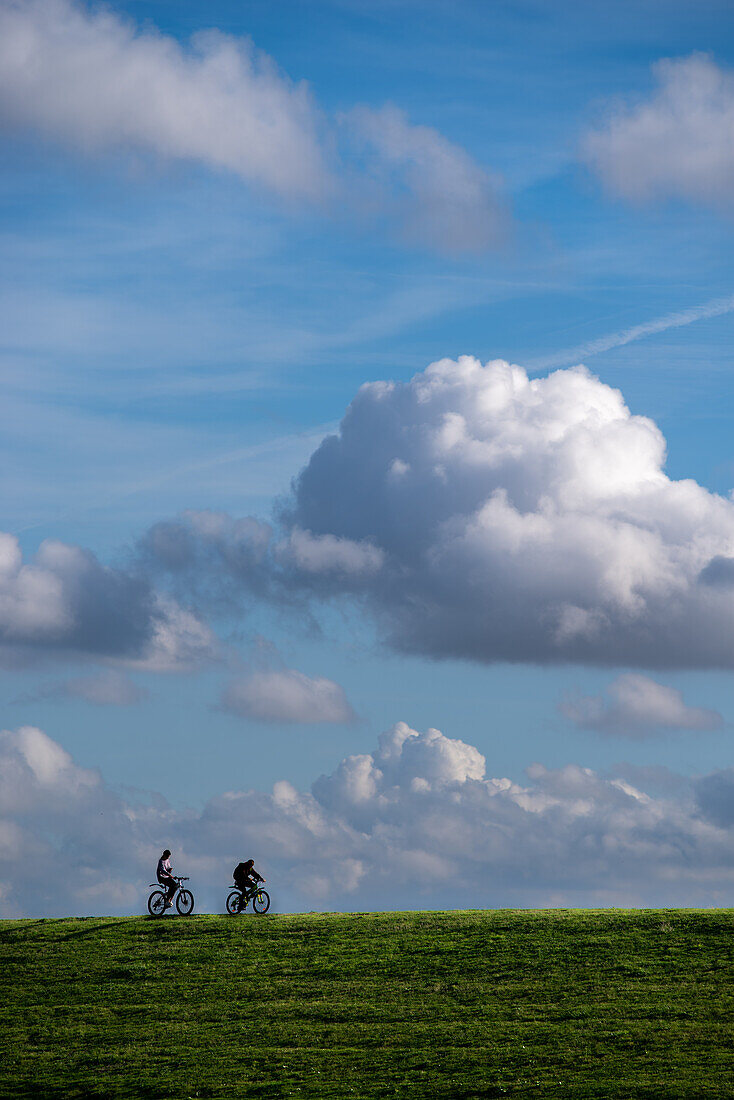 People cycling on a sunny september day in Groede, the Netherlands.