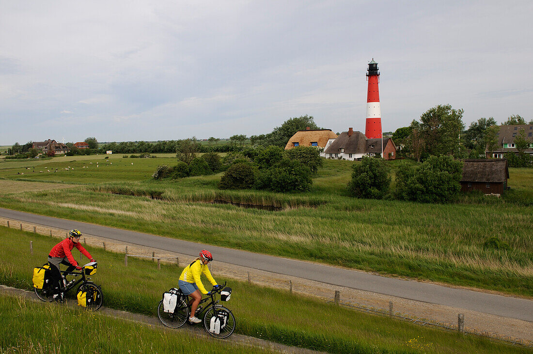 Cyclists in front of the lighthouse on the island of Pellworm, North Friesland, North Sea, Schleswig-Holstein, Germany, MR