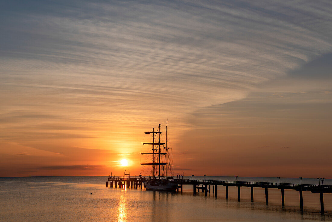 Binz pier, sailing ship, sunrise, Binz, Ruegen Island, Mecklenburg-West Pomerania, Germany
