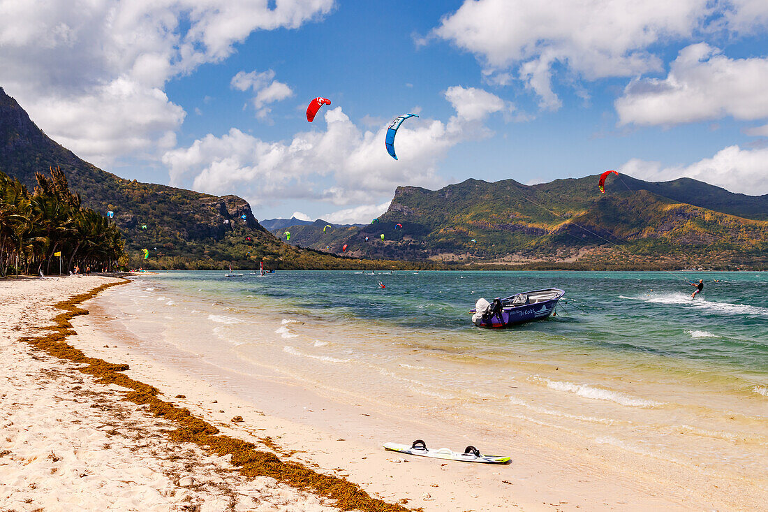 A kite surfer and a boat on Le Morne beach on the island of Mauritius, Indian Ocean