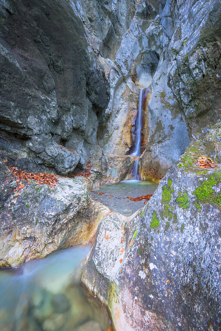 Hidden waterfall with beautiful rock formations in the Bavarian mountains.