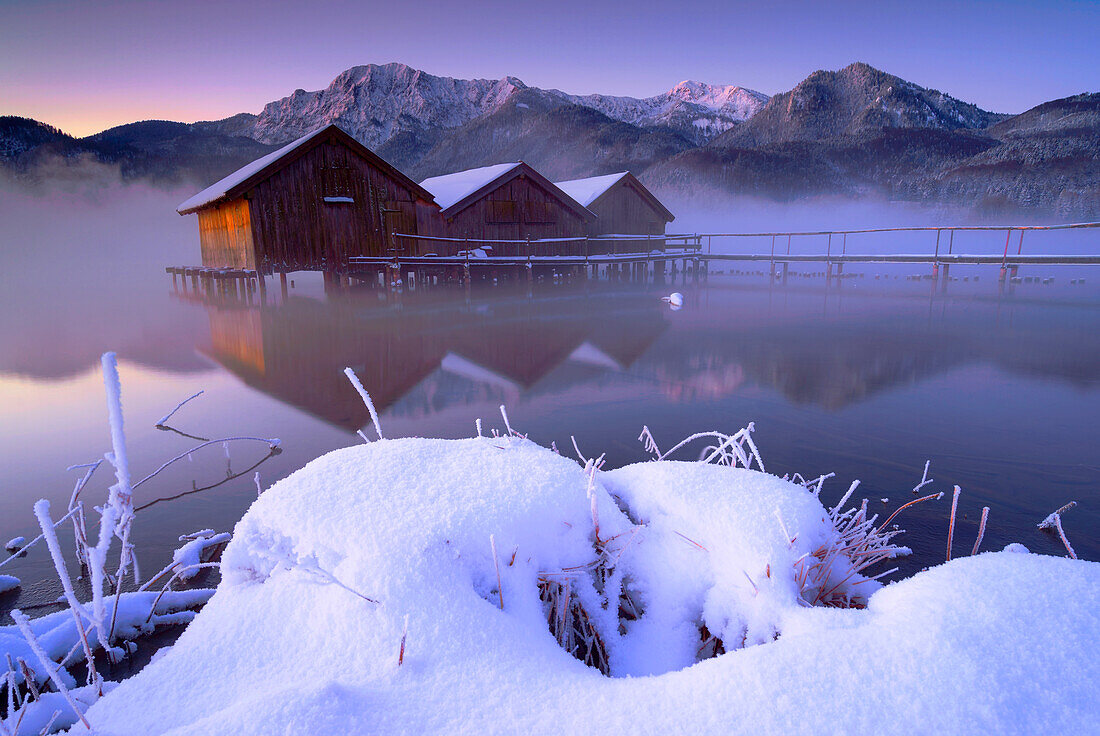 Three fishing huts on the shore of Lake Kochel in Schlehdorf.