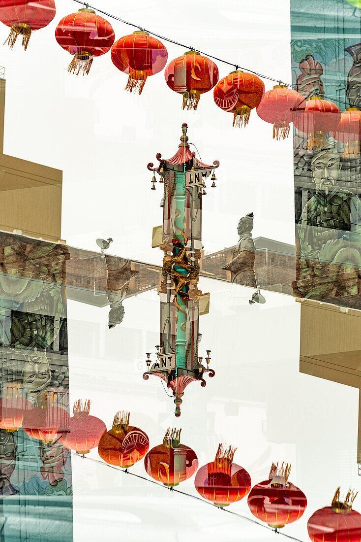 Double exposure of Grant Avenue featuring a Chinese statue, a mural and Chinese lanterns in chinatown, San Francisco.